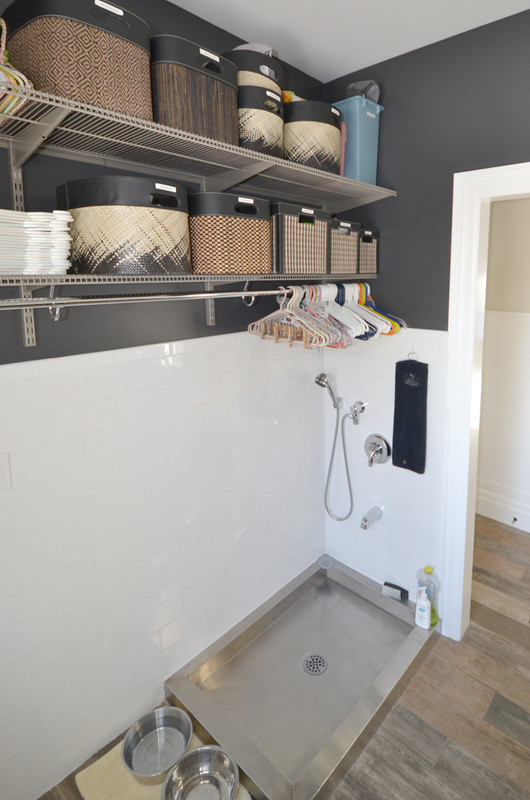 This is an example of a transitional utility room in Toronto with blue walls and porcelain floors.