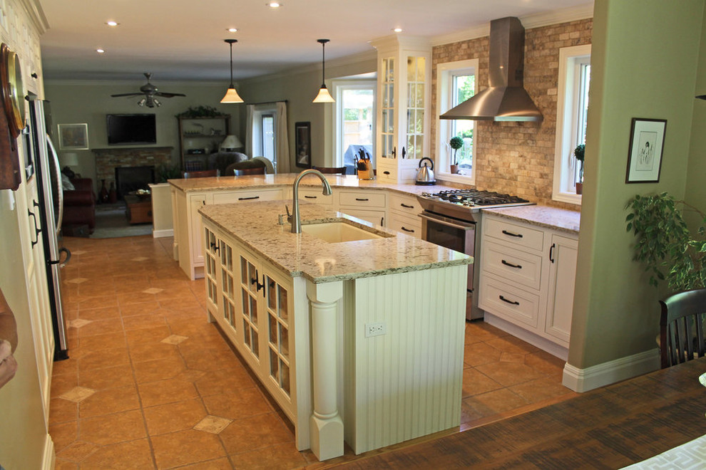 Inspiration for a mid-sized transitional u-shaped open concept kitchen remodel with an undermount sink, beaded inset cabinets, white cabinets, granite countertops, gray backsplash, ceramic backsplash, stainless steel appliances, an island and beige countertops