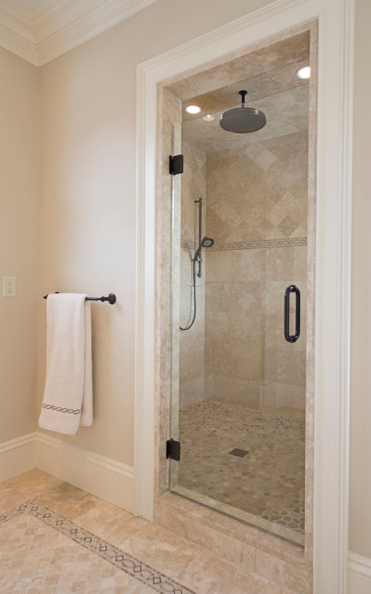 Mid-sized traditional master bathroom in Boston with an alcove shower, beige tile, ceramic tile, beige walls, travertine floors, beige floor and a hinged shower door.