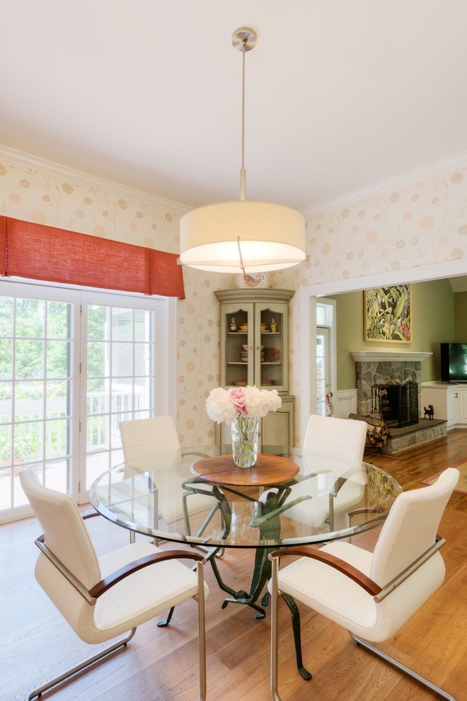 Transitional medium tone wood floor dining room photo in Boston with an undermount sink, raised-panel cabinets, white cabinets, granite countertops, white backsplash, paneled appliances and an island