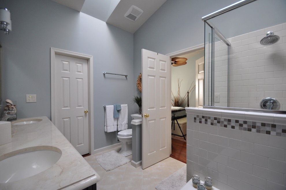 Design ideas for a mid-sized transitional master bathroom in DC Metro with a corner shower, white tile, porcelain tile, blue walls, porcelain floors, an undermount sink, engineered quartz benchtops and beige floor.
