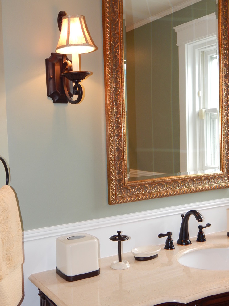 Photo of a mid-sized traditional master bathroom in Other with furniture-like cabinets, dark wood cabinets, an alcove tub, a shower/bathtub combo, a two-piece toilet, beige tile, porcelain tile, green walls, porcelain floors, an undermount sink, marble benchtops, beige floor and a shower curtain.