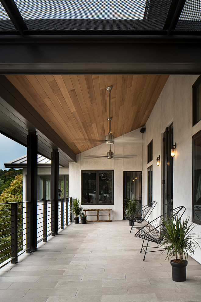 Inspiration for a contemporary balcony in Austin with a roof extension.
