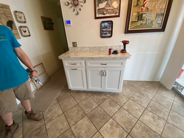 Large galley eat-in kitchen photo with shaker cabinets, white cabinets, laminate countertops, a peninsula and white countertops
