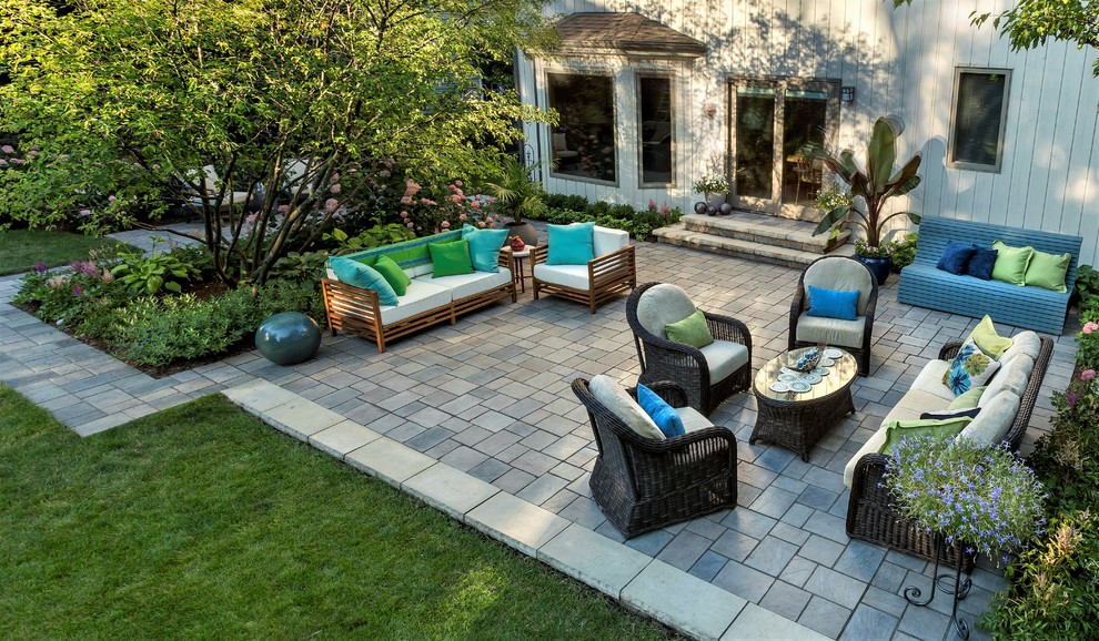 Design ideas for a mid-sized contemporary backyard patio in Chicago with a container garden, brick pavers and no cover.