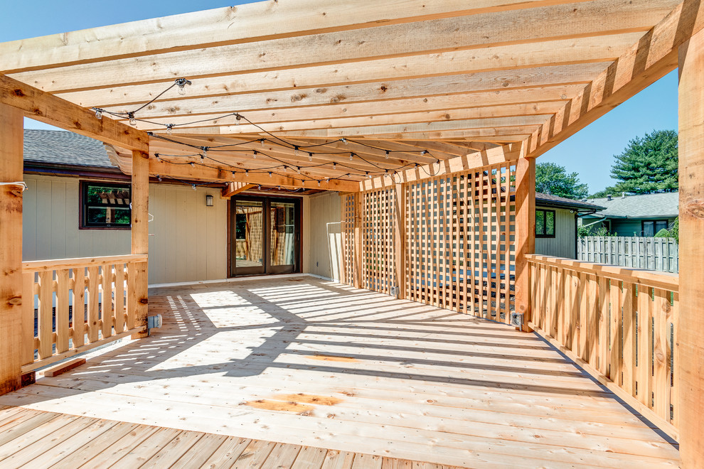 Large transitional backyard deck photo in Chicago with a pergola