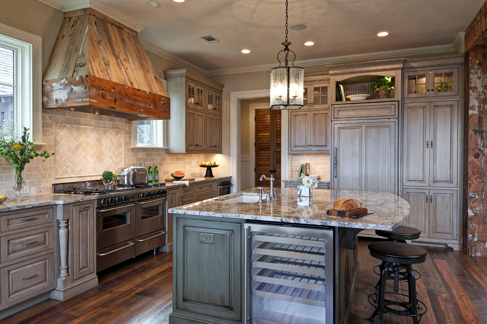 Inspiration for a country kitchen in Jacksonville with an undermount sink, raised-panel cabinets, distressed cabinets, beige splashback, stainless steel appliances, medium hardwood floors and with island.
