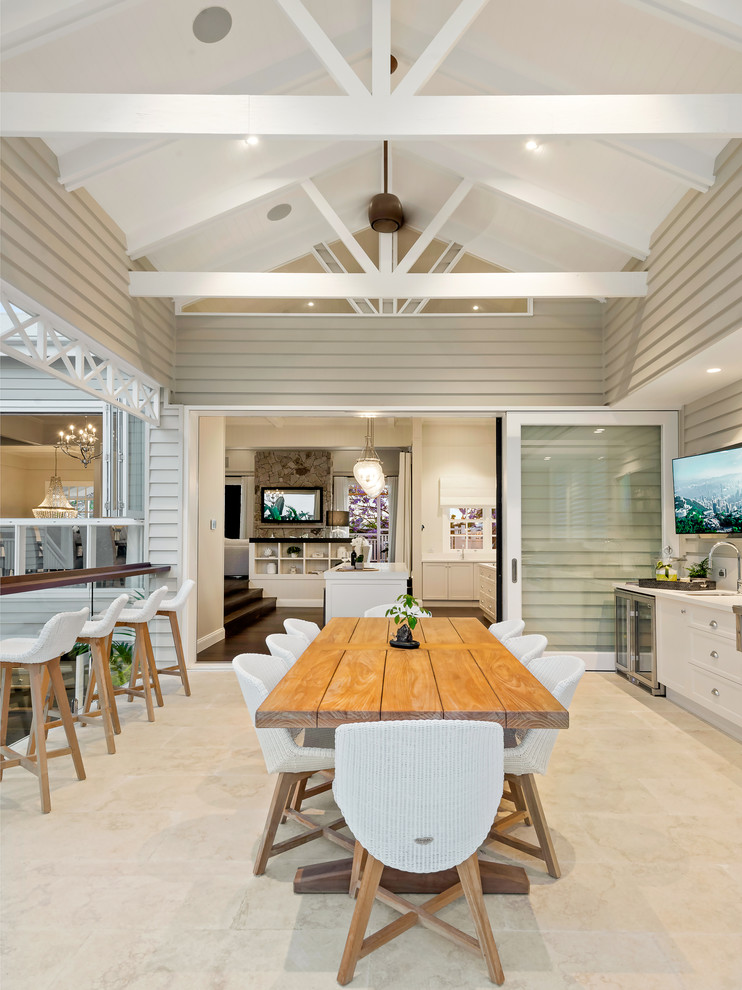 Inspiration for a large beach style patio in Brisbane with an outdoor kitchen, tile and a roof extension.