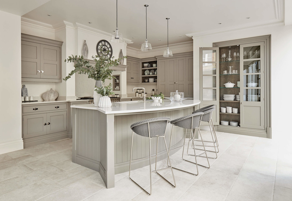 Photo of a large transitional l-shaped eat-in kitchen in Other with a drop-in sink, shaker cabinets, grey cabinets, quartzite benchtops, stainless steel appliances, porcelain floors, with island, beige floor and white benchtop.