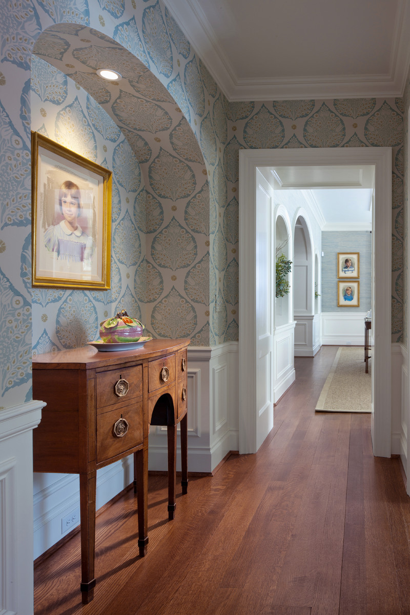 Inspiration for a traditional entryway in Cincinnati with multi-coloured walls, dark hardwood floors and brown floor.