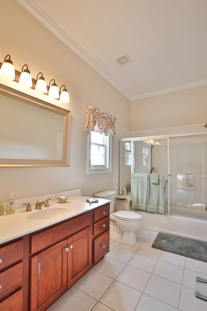 This is an example of a large traditional bathroom in Atlanta with medium wood cabinets.