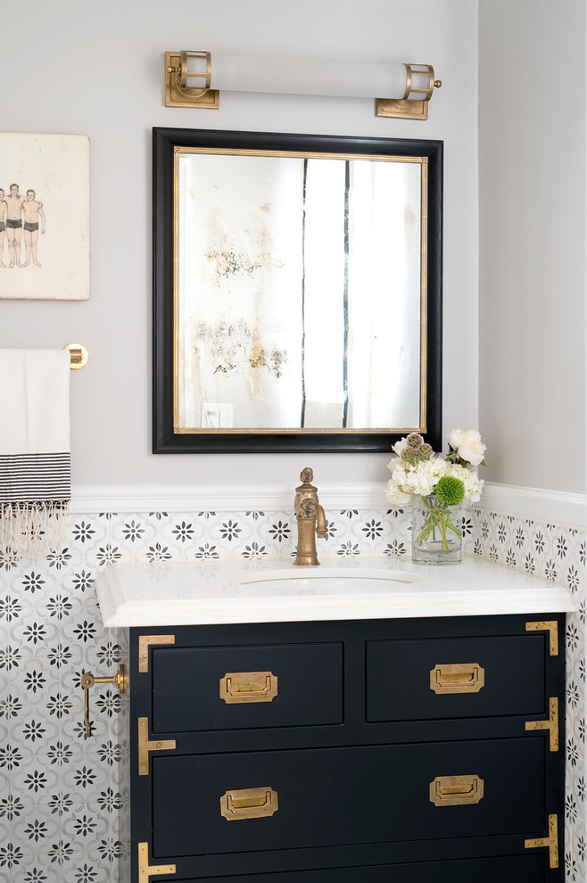 Design ideas for a traditional powder room in San Francisco with flat-panel cabinets, black cabinets, an undermount sink and beige walls.