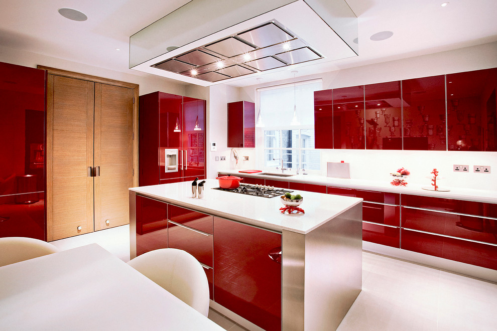 Inspiration for a contemporary l-shaped eat-in kitchen in London with an undermount sink, flat-panel cabinets, red cabinets, white splashback, panelled appliances and with island.
