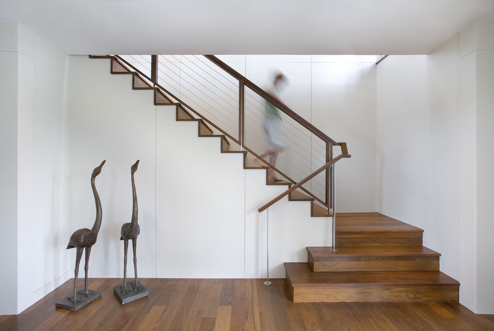 Contemporary wood staircase in Charleston with wood risers.