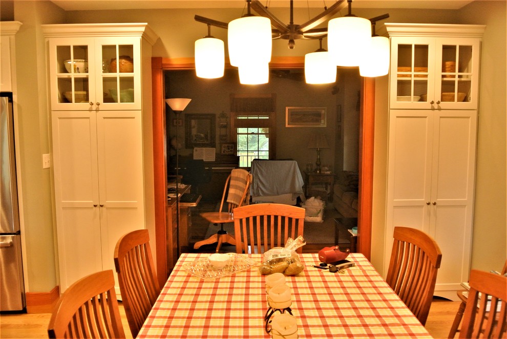 Transitional light wood floor kitchen photo in Boston with an undermount sink, shaker cabinets, white cabinets, quartzite countertops, white backsplash, subway tile backsplash, stainless steel appliances and an island