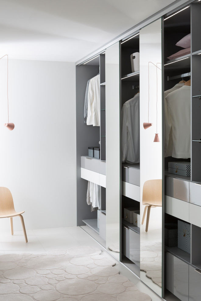 Design ideas for a large contemporary gender-neutral dressing room in Lyon with open cabinets and grey cabinets.