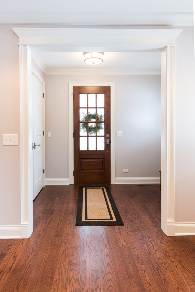 Single front door - small transitional medium tone wood floor and brown floor single front door idea in Chicago with gray walls and a medium wood front door
