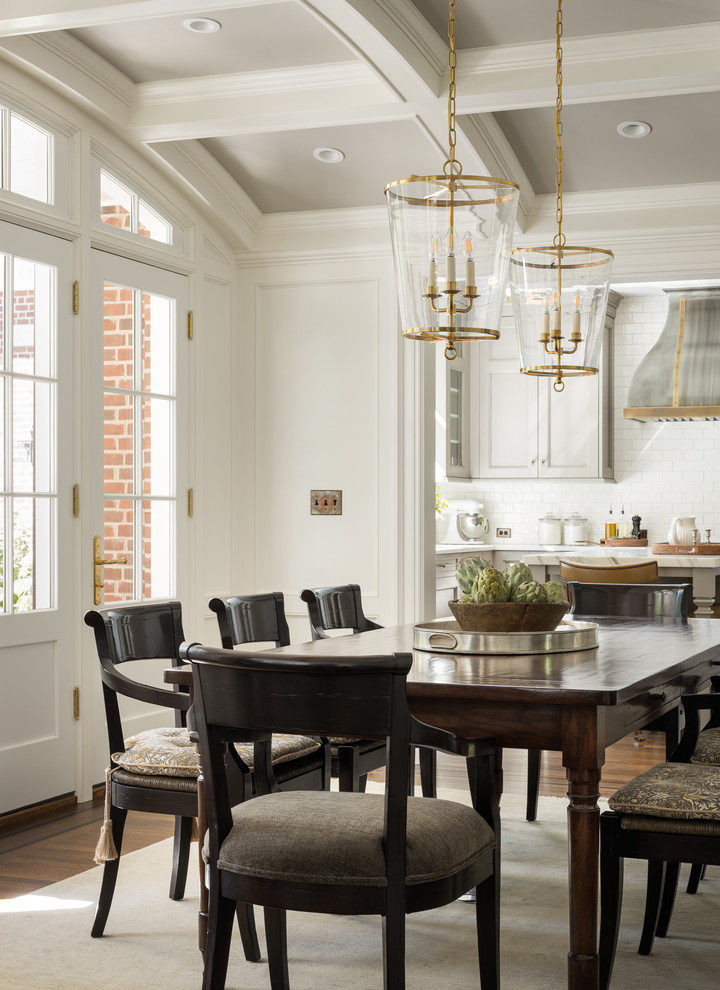 Design ideas for a traditional dining room in New York with white walls, medium hardwood floors and brown floor.