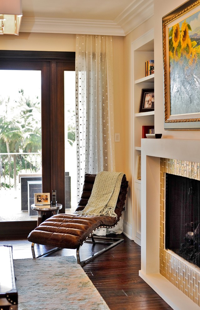 Contemporary living room in Miami with a standard fireplace and a tile fireplace surround.