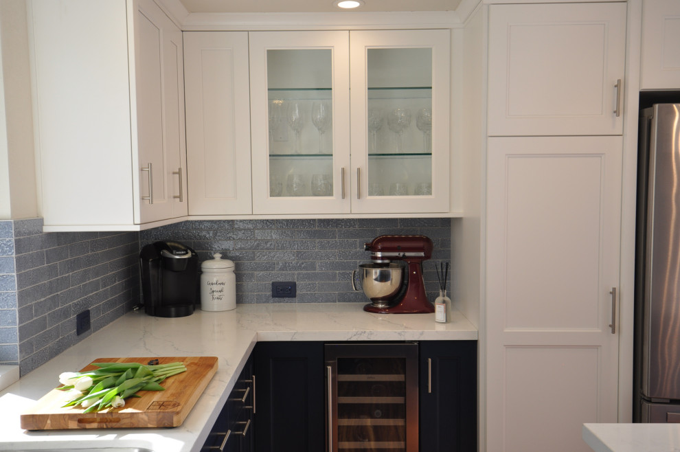 Photo of a mid-sized transitional u-shaped separate kitchen in San Diego with an undermount sink, shaker cabinets, white cabinets, quartz benchtops, blue splashback, brick splashback, stainless steel appliances, laminate floors, with island, brown floor, white benchtop and coffered.