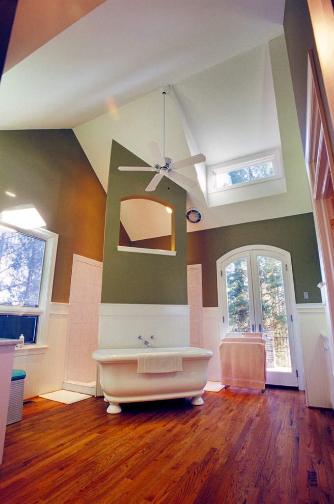 Huge transitional dark wood floor, brown floor, double-sink and vaulted ceiling freestanding bathtub photo in Charleston with green walls and white countertops