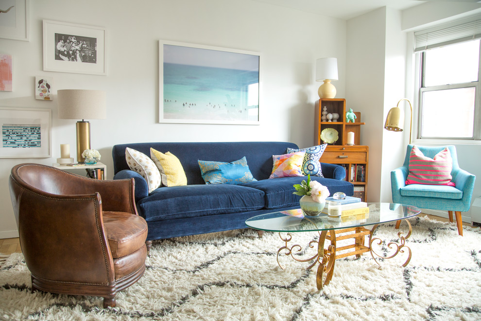 Inspiration for a small 1960s loft-style light wood floor living room remodel in New York with white walls and no fireplace