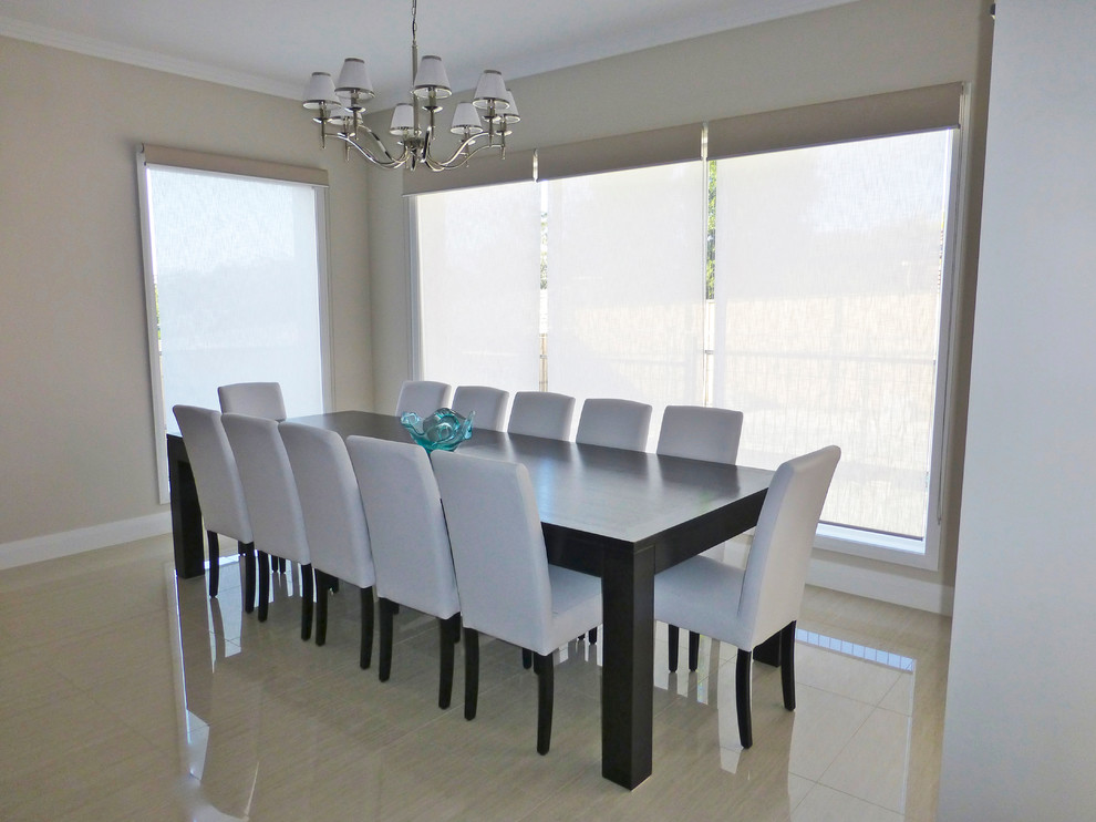 This is an example of an expansive transitional open plan dining in Sydney with beige walls and ceramic floors.