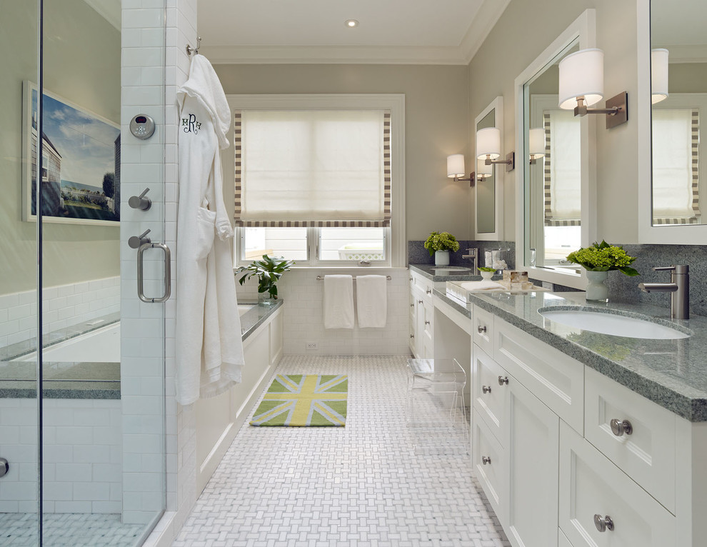 This is an example of a contemporary bathroom in San Francisco with an undermount tub, an undermount sink and grey benchtops.