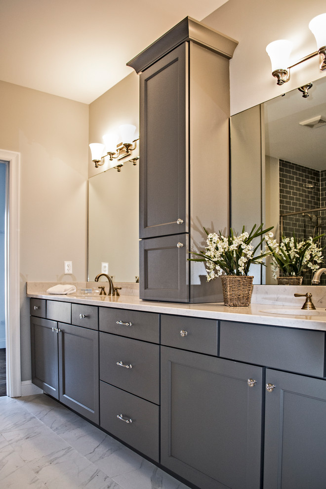 Mid-sized arts and crafts master bathroom in St Louis with recessed-panel cabinets, grey cabinets, an alcove shower, a two-piece toilet, white tile, porcelain tile, grey walls, marble floors, an undermount sink, granite benchtops, white floor and a hinged shower door.