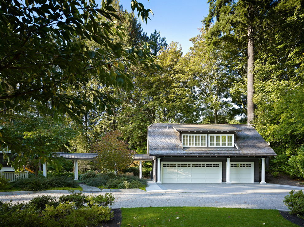 Photo of a traditional detached three-car garage in Seattle.