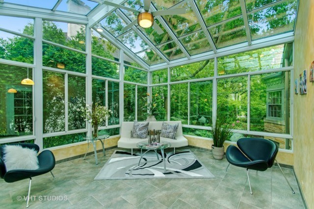 Photo of a mid-sized modern sunroom in Chicago with terra-cotta floors, a glass ceiling and grey floor.
