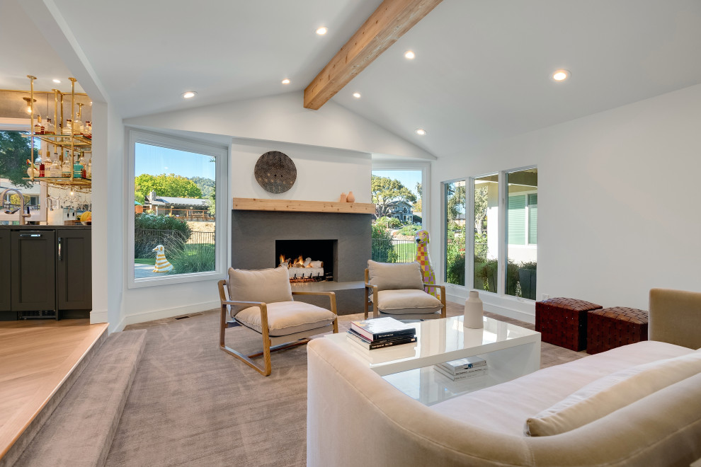 Inspiration for an expansive formal open concept living room in San Francisco with light hardwood floors, a standard fireplace, a concrete fireplace surround, brown floor and exposed beam.