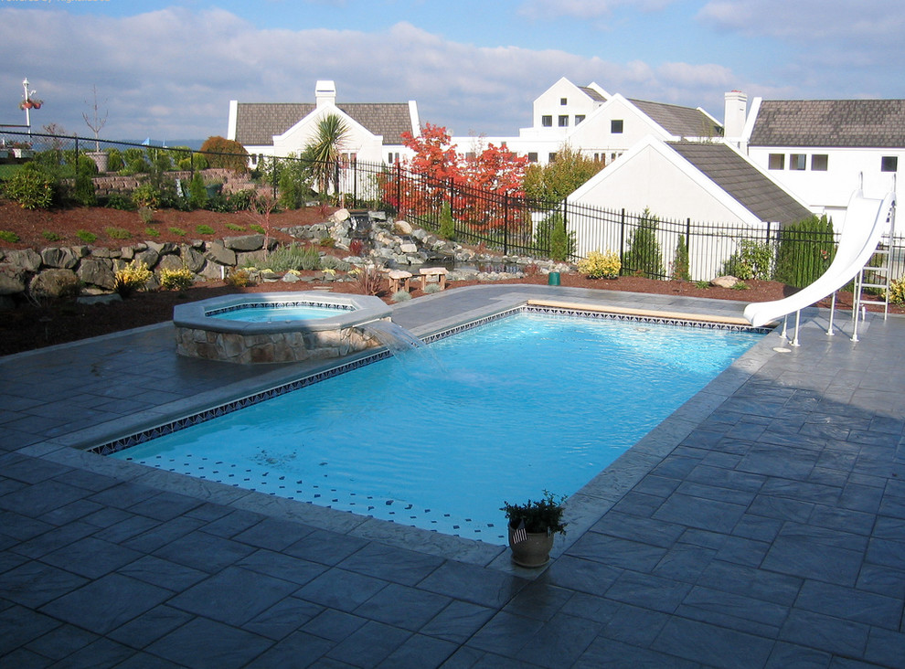Water slide - mid-sized backyard stamped concrete and rectangular natural water slide idea in Cincinnati