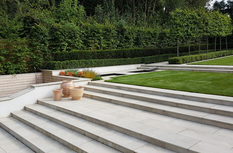 Large contemporary back formal partial sun garden in West Midlands.