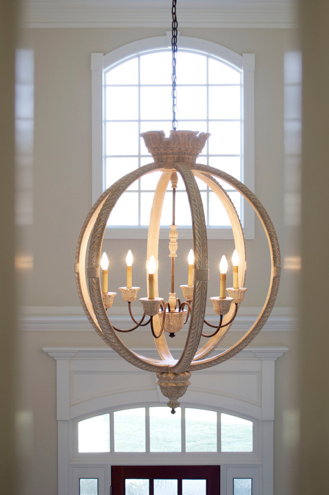 Inspiration for a large transitional medium tone wood floor foyer remodel with beige walls