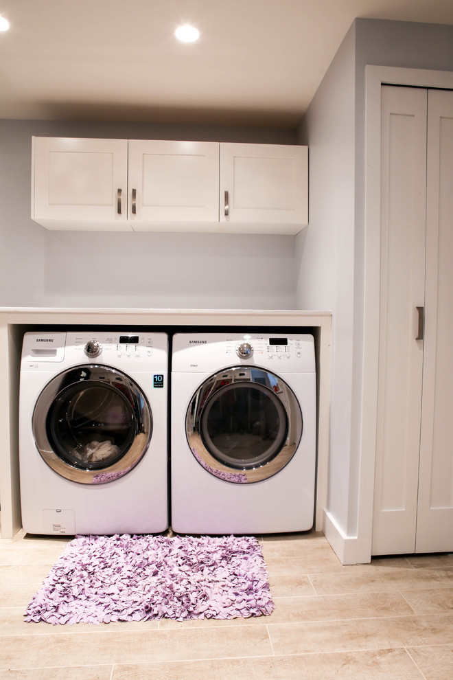 Mid-sized traditional single-wall dedicated laundry room in Vancouver with shaker cabinets, white cabinets, quartz benchtops, ceramic floors, a side-by-side washer and dryer and grey walls.