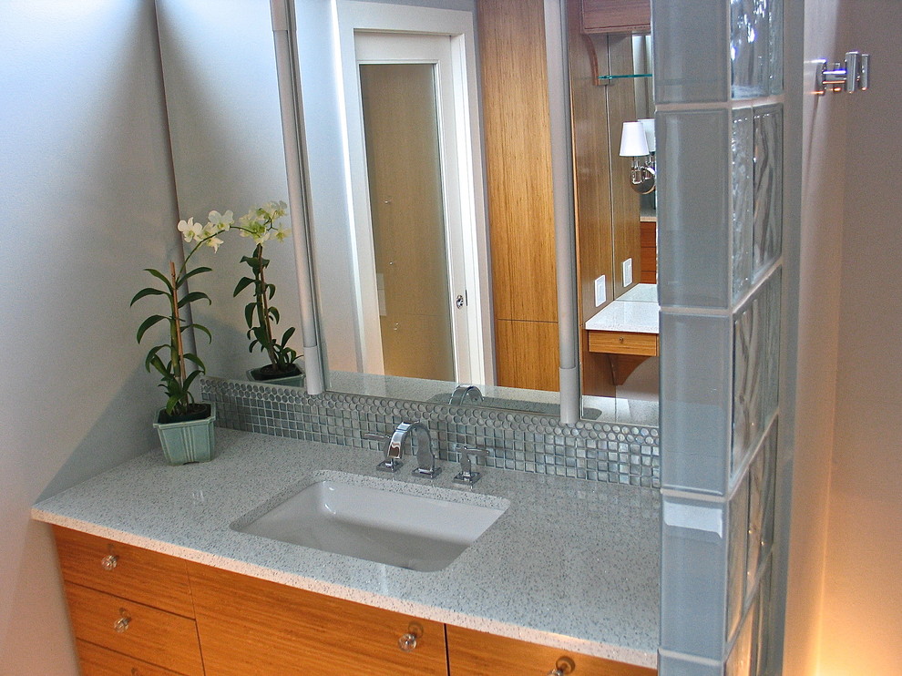 Small modern master bathroom in Portland with an undermount sink, flat-panel cabinets, medium wood cabinets, engineered quartz benchtops, a curbless shower, a two-piece toilet, white tile, glass tile, grey walls and linoleum floors.