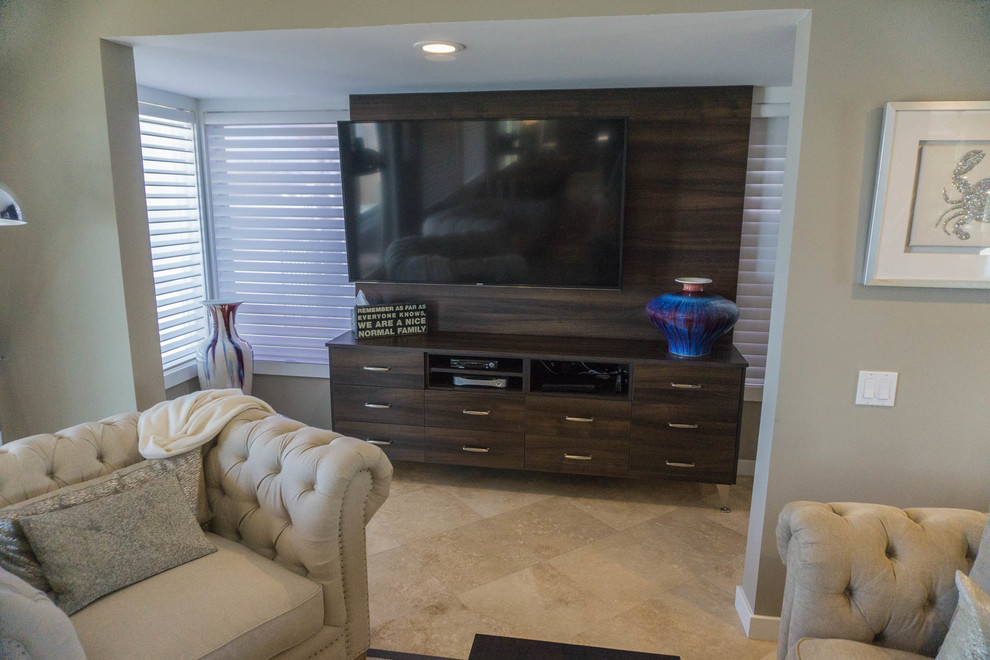 This is an example of an expansive modern open concept family room in San Diego with travertine floors, no fireplace, a built-in media wall and grey walls.