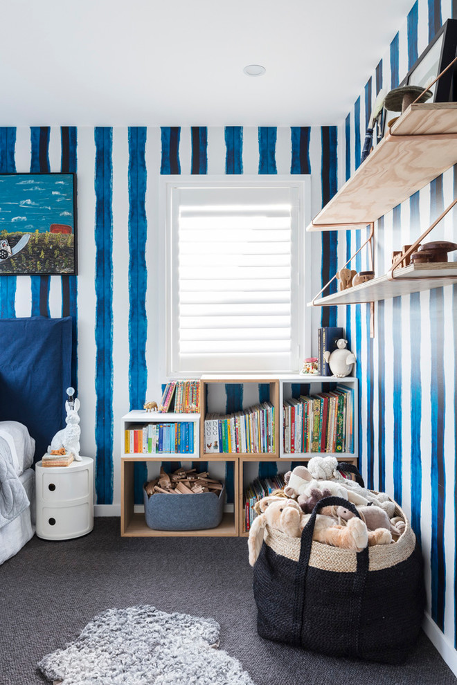 Inspiration for a mid-sized contemporary nursery for boys in Sydney with blue walls, carpet and grey floor.