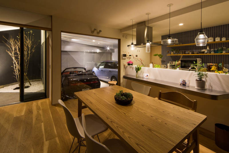 This is an example of a mid-sized modern kitchen/dining combo in Kobe with white walls, medium hardwood floors, wallpaper and wallpaper.