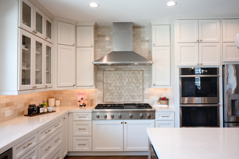Inspiration for a large transitional l-shaped vinyl floor and brown floor open concept kitchen remodel in San Diego with an undermount sink, shaker cabinets, white cabinets, quartz countertops, beige backsplash, porcelain backsplash, stainless steel appliances, an island and white countertops