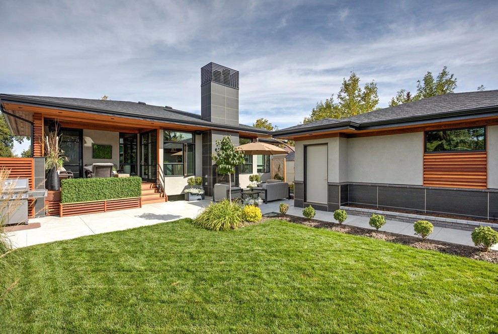 Mid-sized contemporary one-storey brown exterior in Calgary with mixed siding and a hip roof.