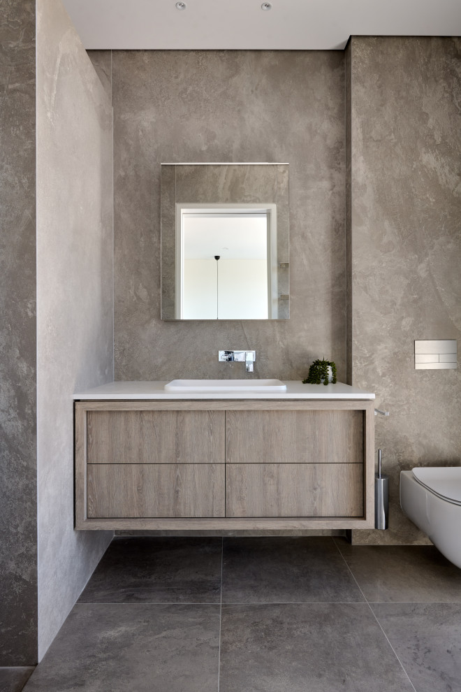 Large contemporary 3/4 bathroom in Perth with flat-panel cabinets, grey cabinets, an open shower, a wall-mount toilet, gray tile, porcelain tile, grey walls, porcelain floors, a drop-in sink, engineered quartz benchtops, black floor, an open shower, white benchtops, a single vanity and a floating vanity.