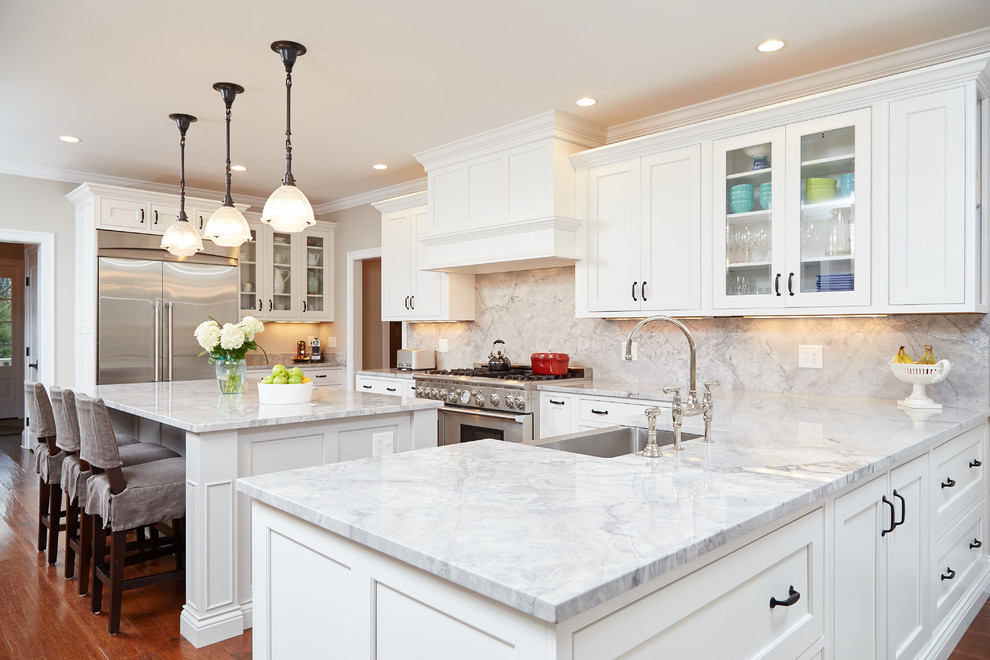 Inspiration for a traditional kitchen in Boston with a farmhouse sink, beaded inset cabinets, white cabinets, marble benchtops, white splashback, subway tile splashback, stainless steel appliances, medium hardwood floors and with island.