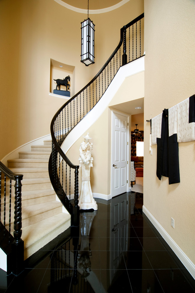 Inspiration for a large asian carpeted curved staircase in Dallas with carpet risers.