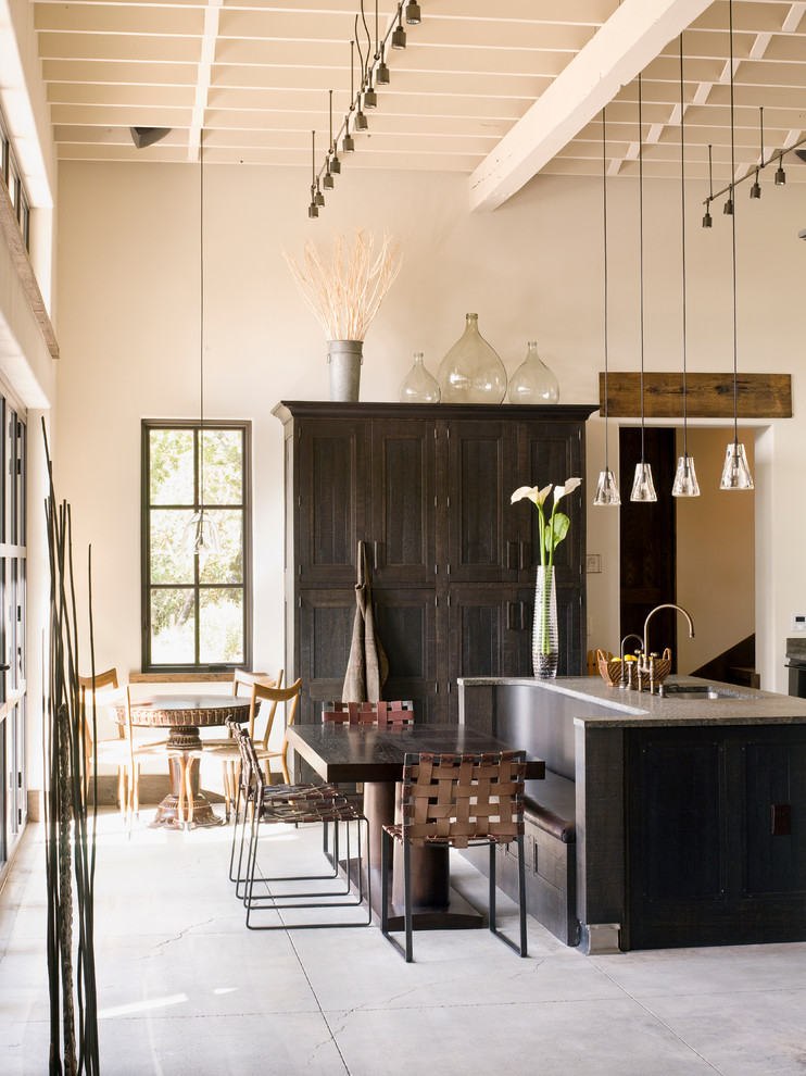 Country kitchen/dining combo in San Francisco with white walls.