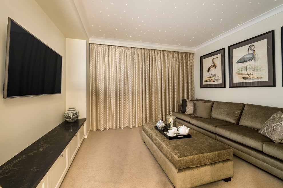 Mid-sized tropical home theatre in Brisbane with white walls, carpet and a wall-mounted tv.