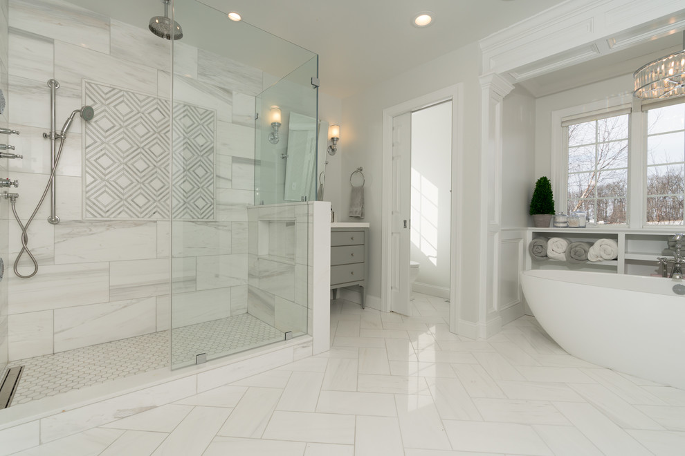Photo of a large contemporary master bathroom in Other with flat-panel cabinets, grey cabinets, a freestanding tub, a double shower, white tile, marble, grey walls, marble floors, an undermount sink, quartzite benchtops, white floor and a hinged shower door.