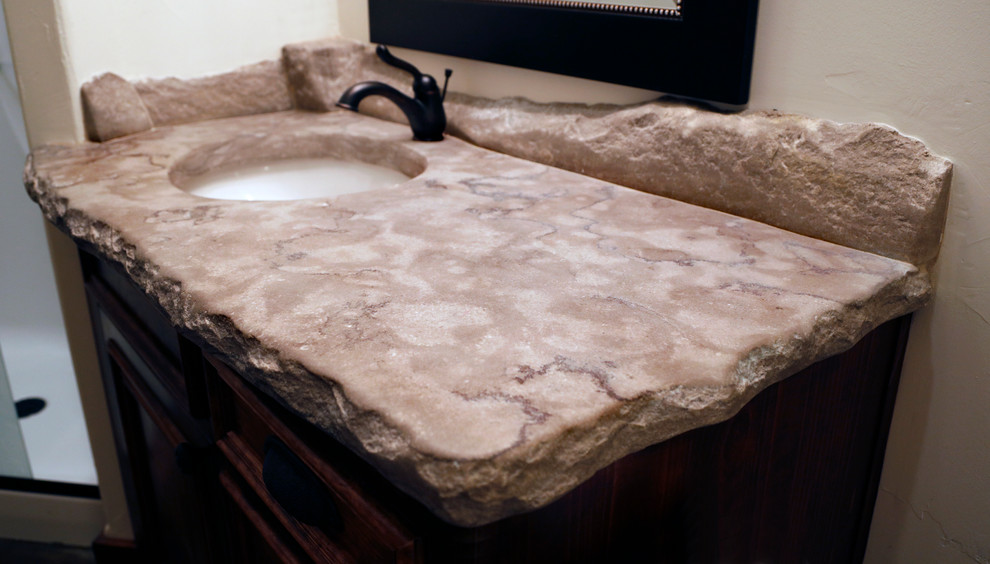 Mid-sized mountain style 3/4 ceramic tile and beige floor bathroom photo with recessed-panel cabinets, dark wood cabinets, a two-piece toilet, beige walls, an integrated sink and concrete countertops