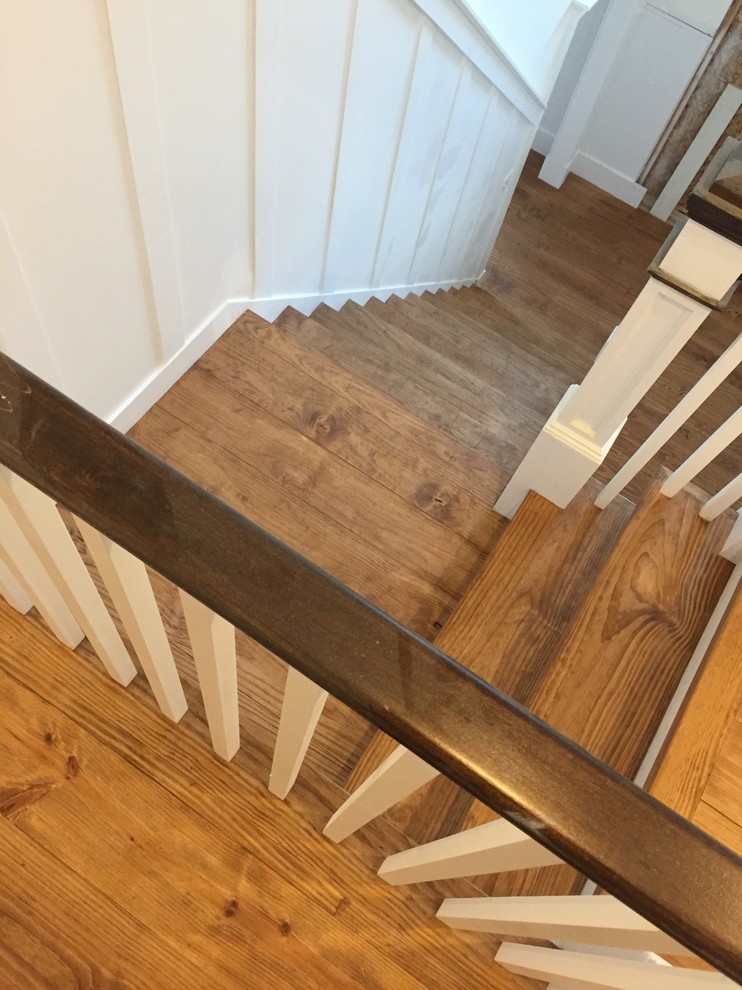 Photo of a mid-sized country wood l-shaped staircase in New York with painted wood risers.